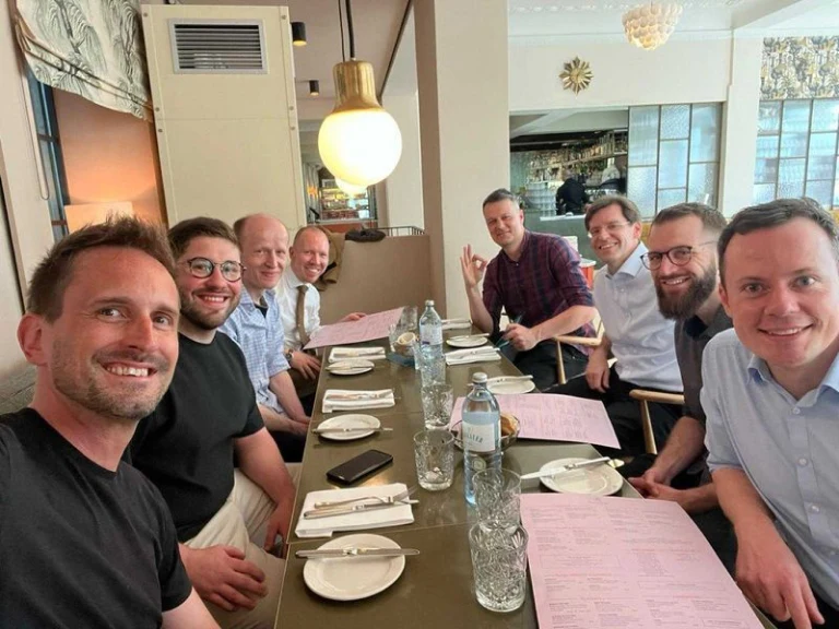 hema.to founders and investors gathered around a table
